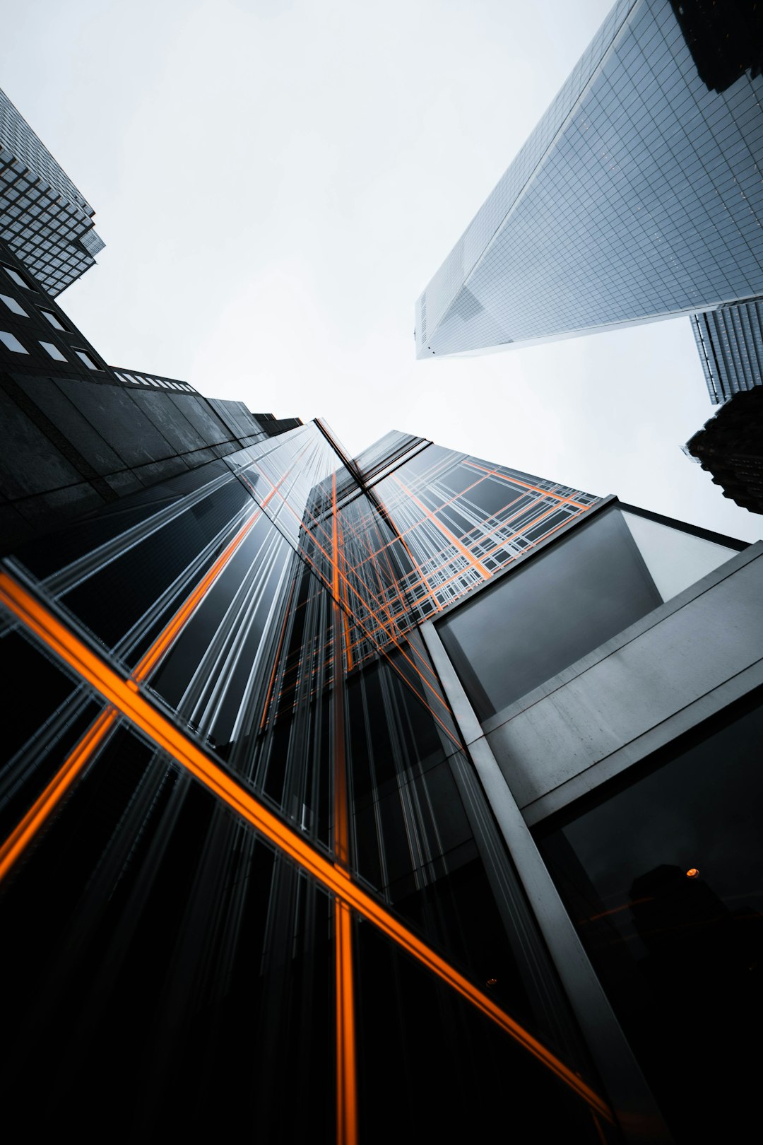 Photo by Donny Jiang low-angle photo of high-rise buildings under white sky